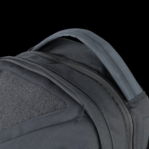 Close-up of the upper section of the Condor Elite Fail Safe Urban Backpack Gen II 18L by Condor, highlighting its padded shoulder straps and reinforced carrying handle.